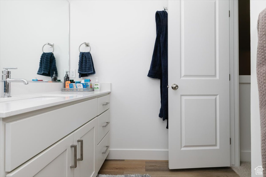 Bathroom with hardwood / wood-style flooring and vanity