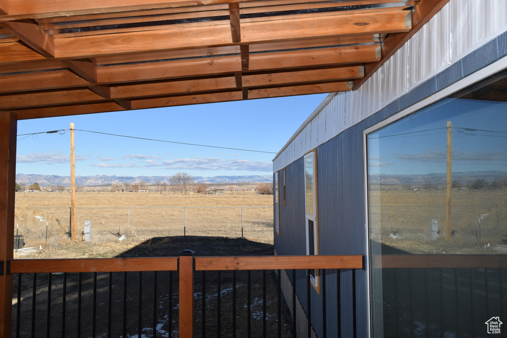 View of yard with a rural view and fence