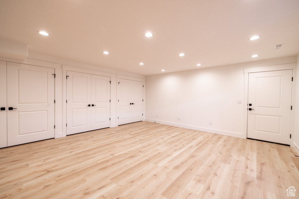 Basement with recessed lighting and light wood-style flooring