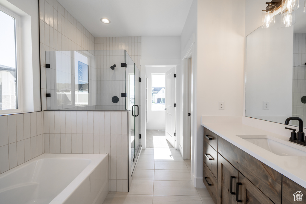 Bathroom with a garden tub, vanity, a shower stall, tile patterned floors, and recessed lighting