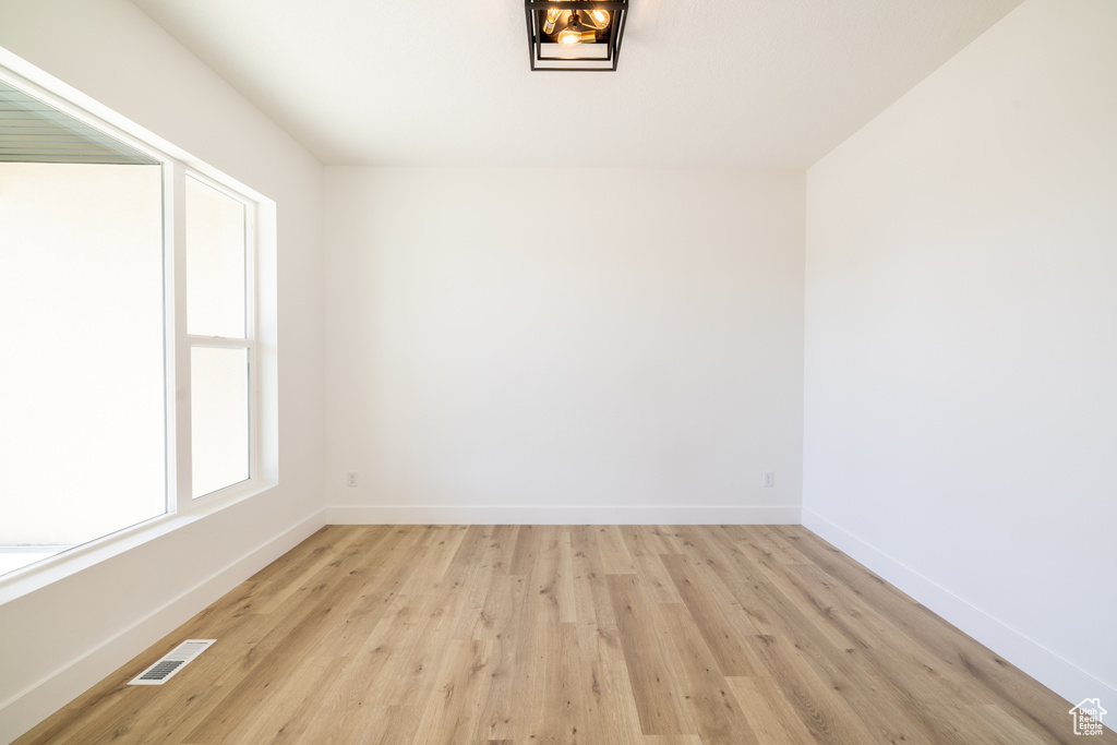 Spare room with light wood-style flooring and baseboards