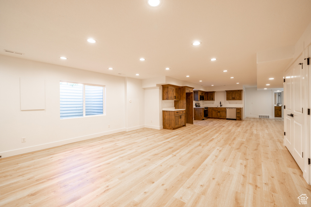 Unfurnished living room featuring recessed lighting and light wood-style floors