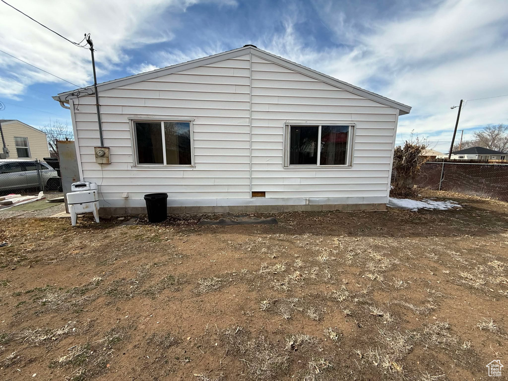 View of home's exterior featuring fence