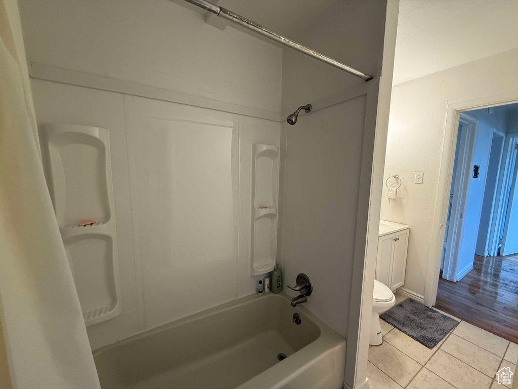 Bathroom featuring toilet, shower / bathing tub combination, vanity, and tile patterned floors