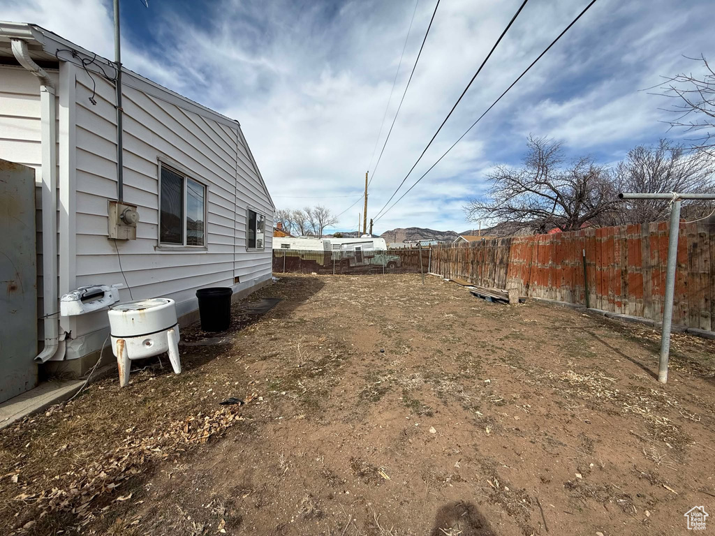 View of yard featuring fence