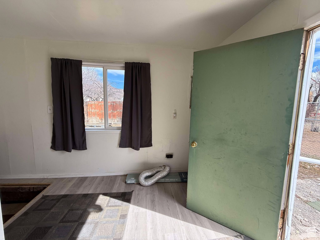 Bathroom with vaulted ceiling and wood finished floors