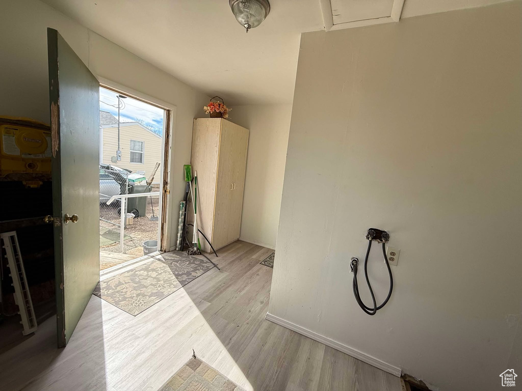 Hall featuring light wood-style flooring and baseboards