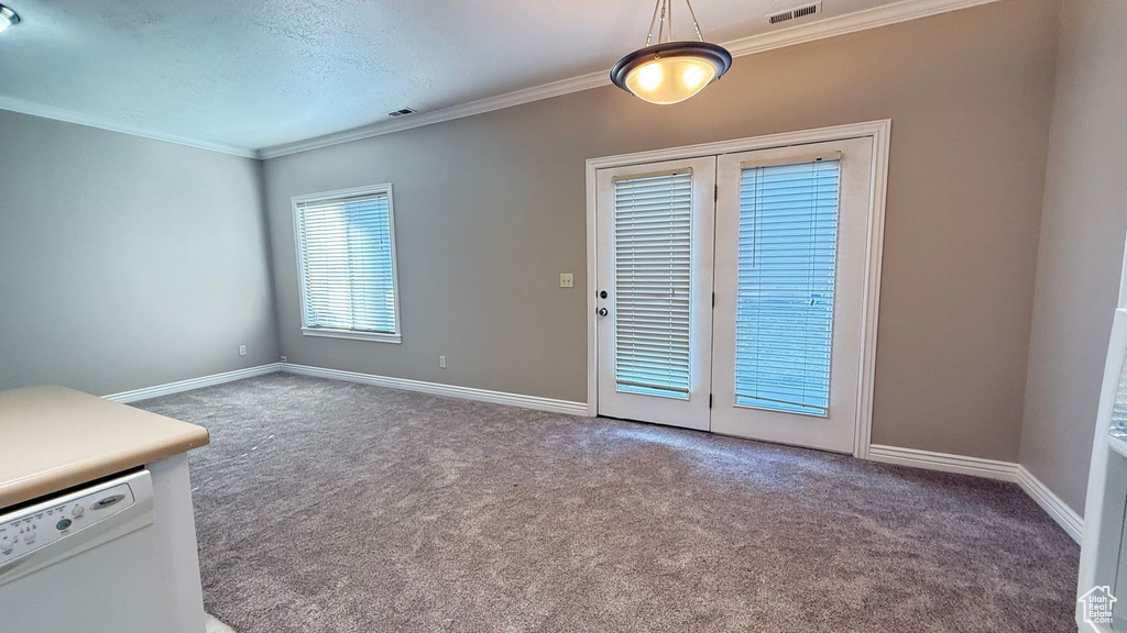 Interior space with baseboards, visible vents, and crown molding