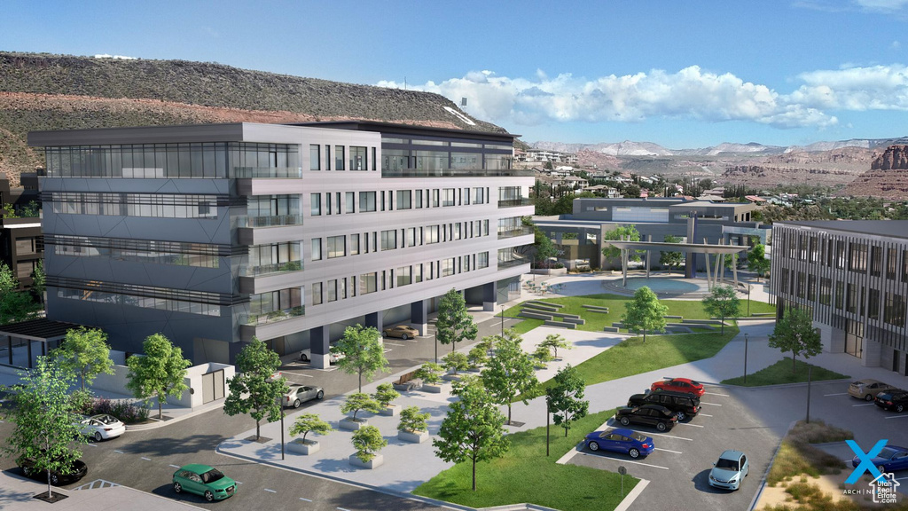 View of building exterior featuring uncovered parking and a mountain view
