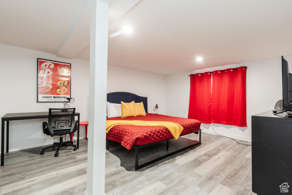 Bedroom with light wood-type flooring and baseboards