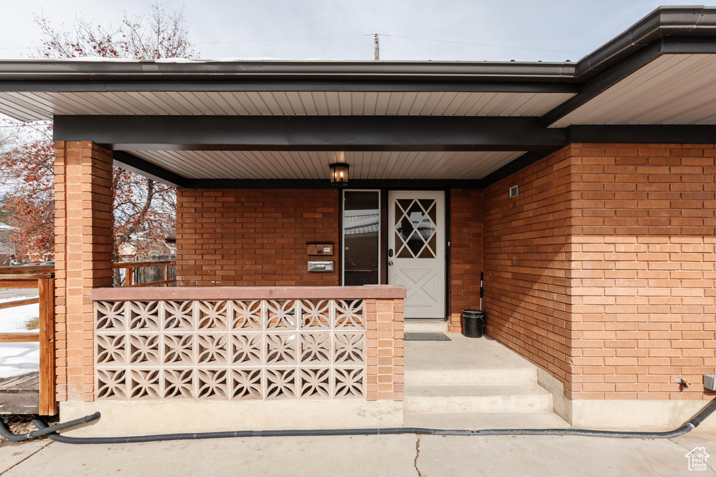 Doorway to property with brick siding