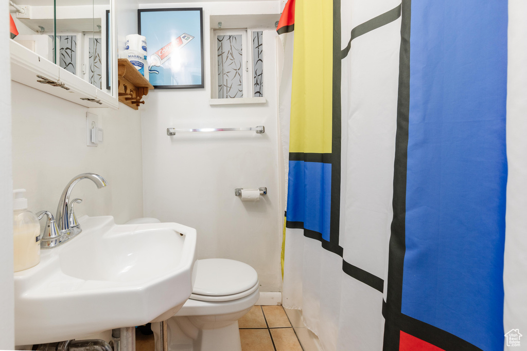 Full bathroom featuring a sink, tile patterned flooring, and toilet