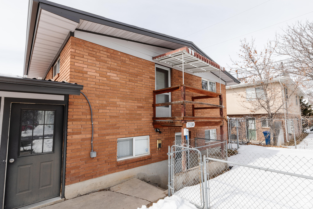 Exterior space with a fenced front yard and brick siding