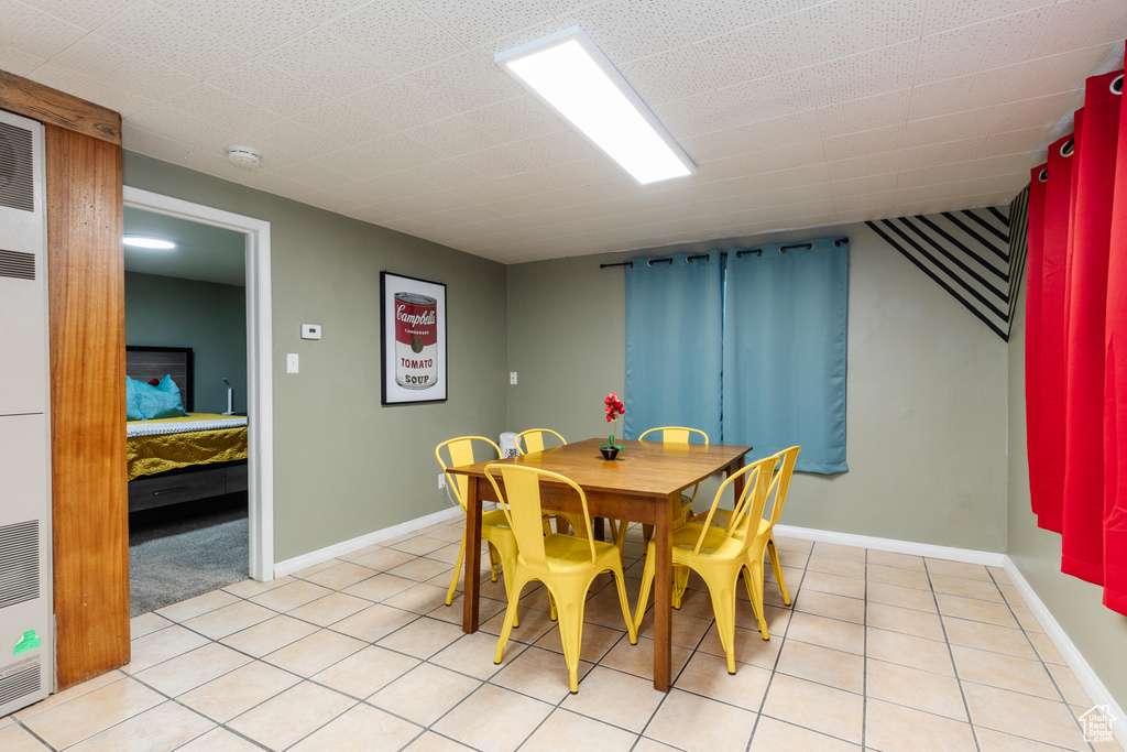 Dining room with baseboards and light tile patterned floors