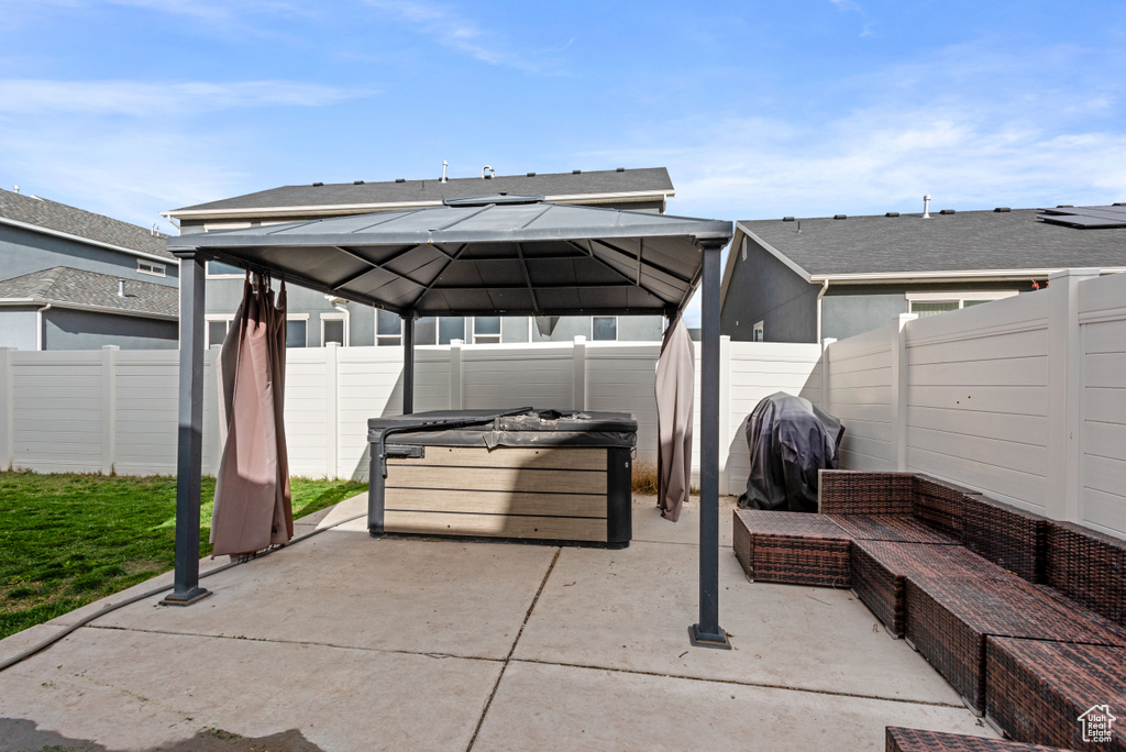 View of patio featuring an outdoor hangout area, a gazebo, area for grilling, and a fenced backyard
