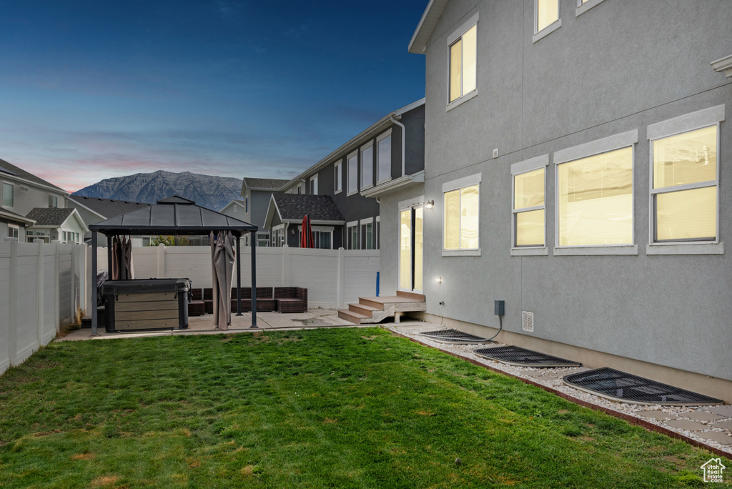 View of yard with a gazebo, a patio, a fenced backyard, and a hot tub