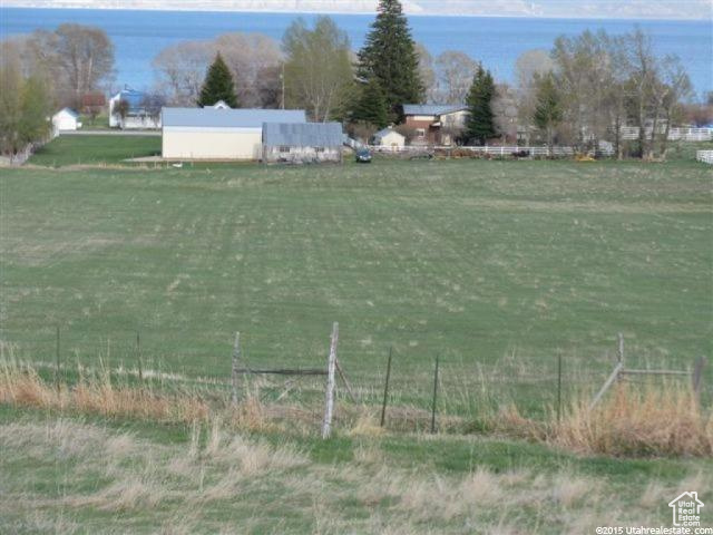 View of yard with fence and a rural view