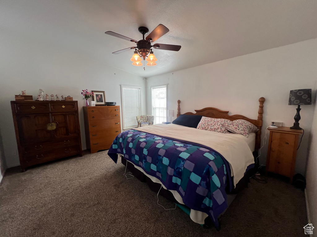 Bedroom with carpet floors, lofted ceiling, and ceiling fan