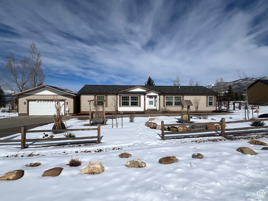 Single story home featuring driveway and an attached garage