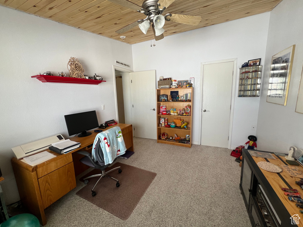 Office area with light carpet, wooden ceiling, visible vents, and a ceiling fan