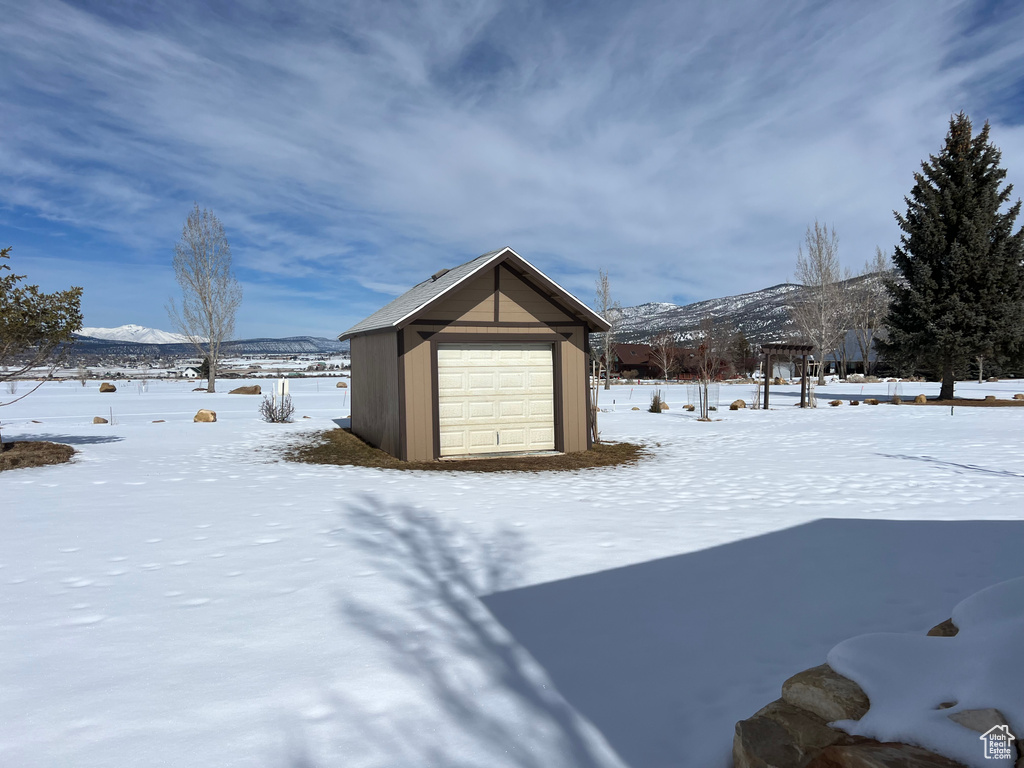 Exterior space featuring an outdoor structure, a mountain view, and a detached garage