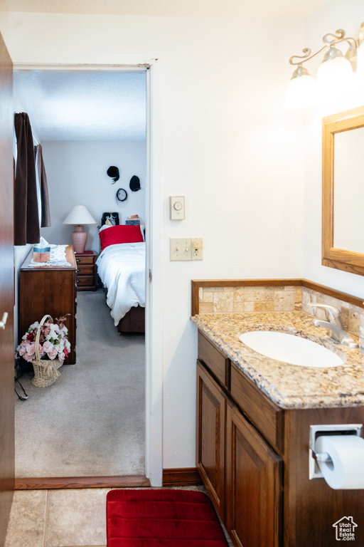 Bathroom featuring connected bathroom and vanity