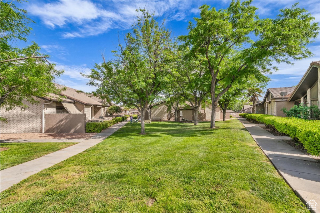 View of green lawn featuring a residential view