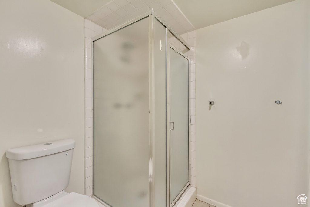 Bathroom with a stall shower and toilet