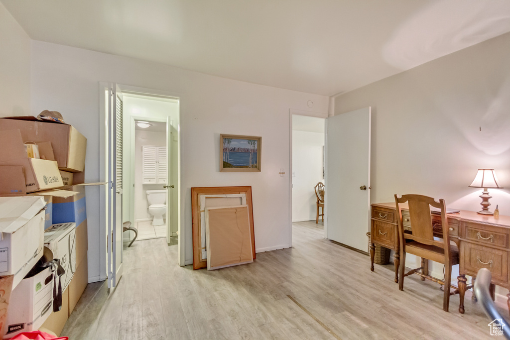 Home office with light wood-style flooring and baseboards