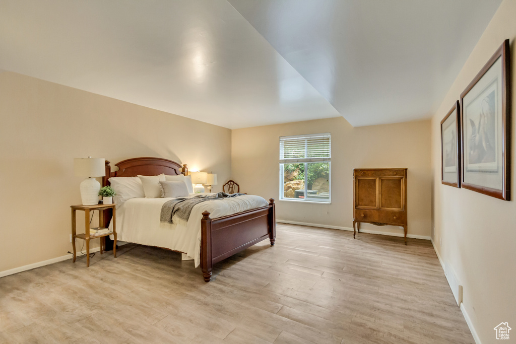 Bedroom featuring light wood-type flooring and baseboards