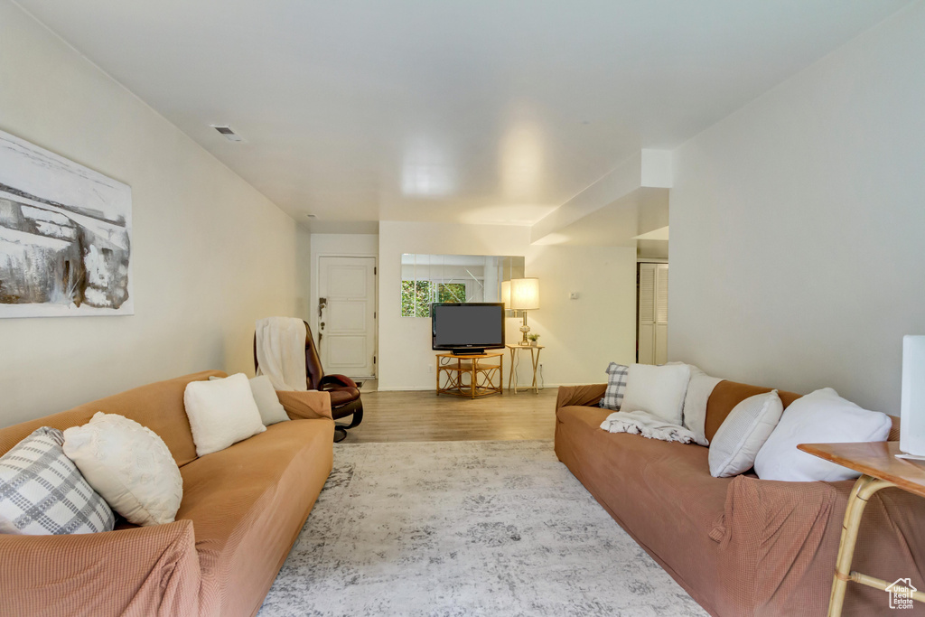 Living area featuring light wood-style floors and visible vents