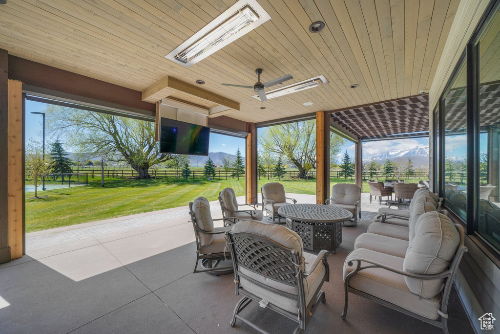View of patio / terrace with an outdoor living space, fence, outdoor dining area, and a ceiling fan