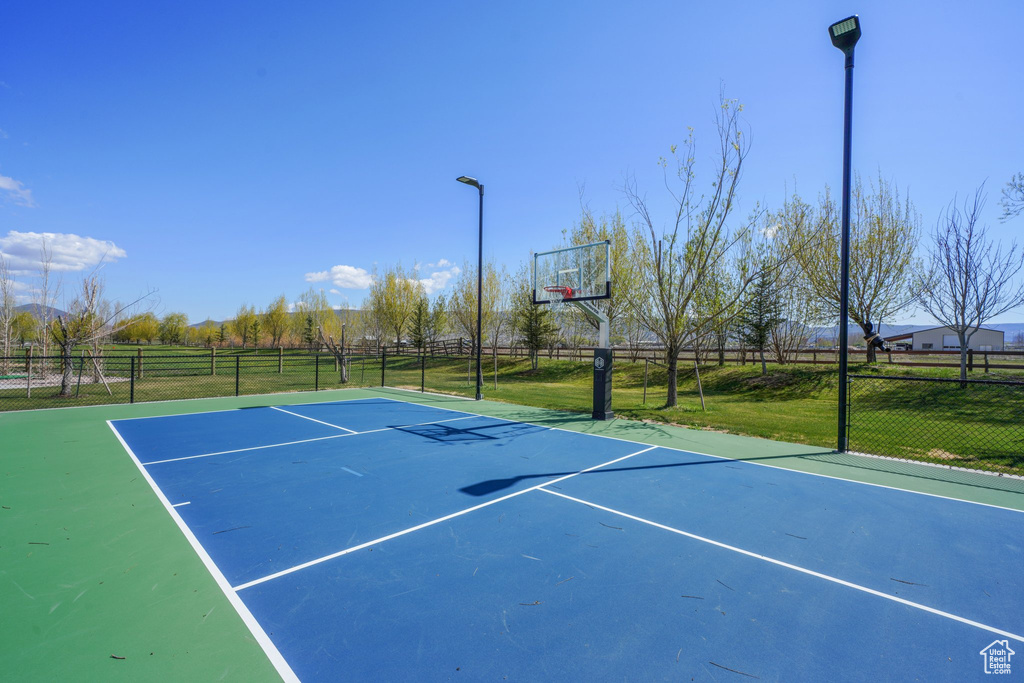 View of basketball court featuring fence and community basketball court
