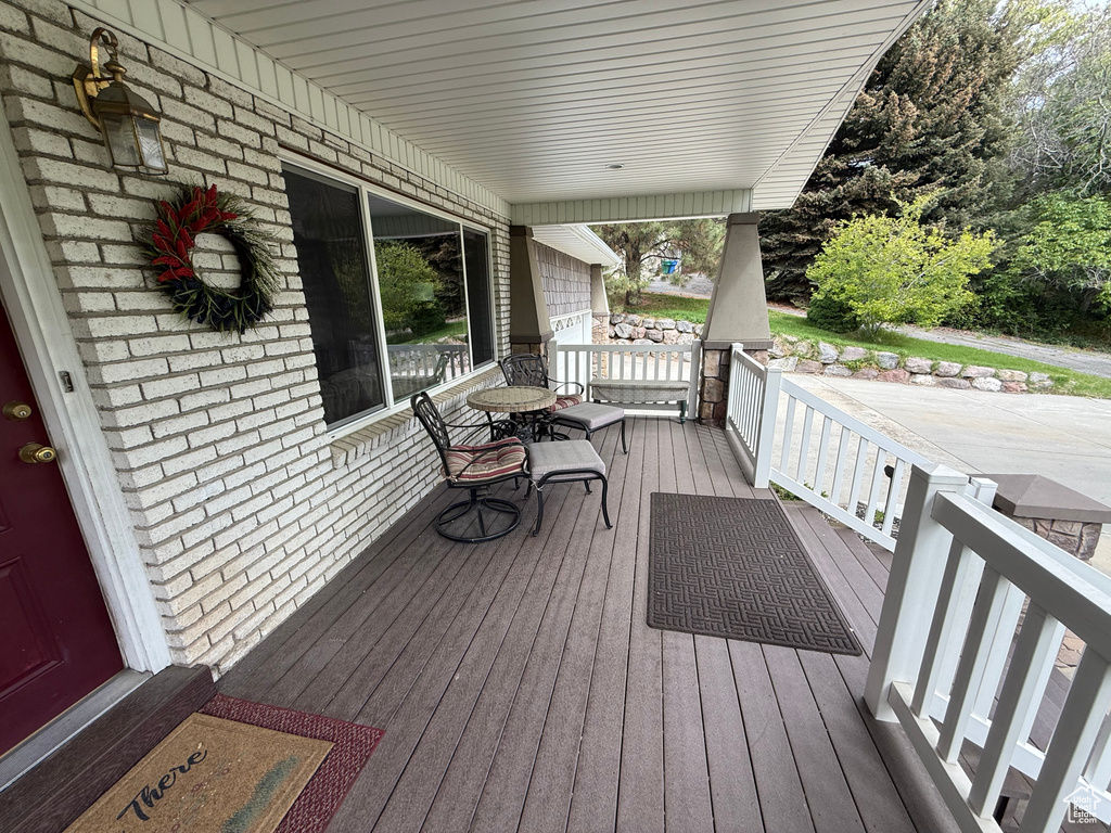 Wooden terrace featuring a porch
