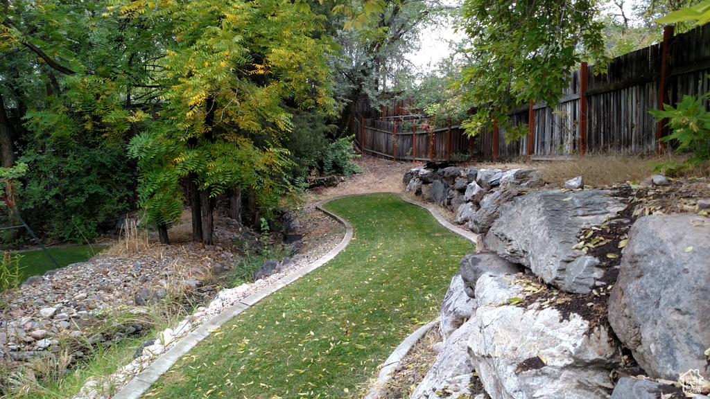 View of yard featuring fence