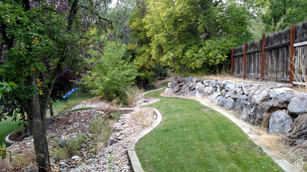 View of yard featuring fence