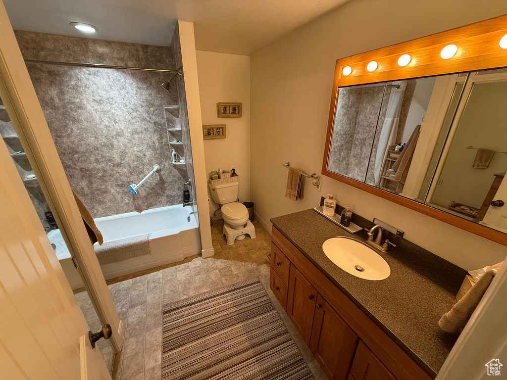 Bathroom with toilet, vanity, shower / bath combination, and tile patterned floors