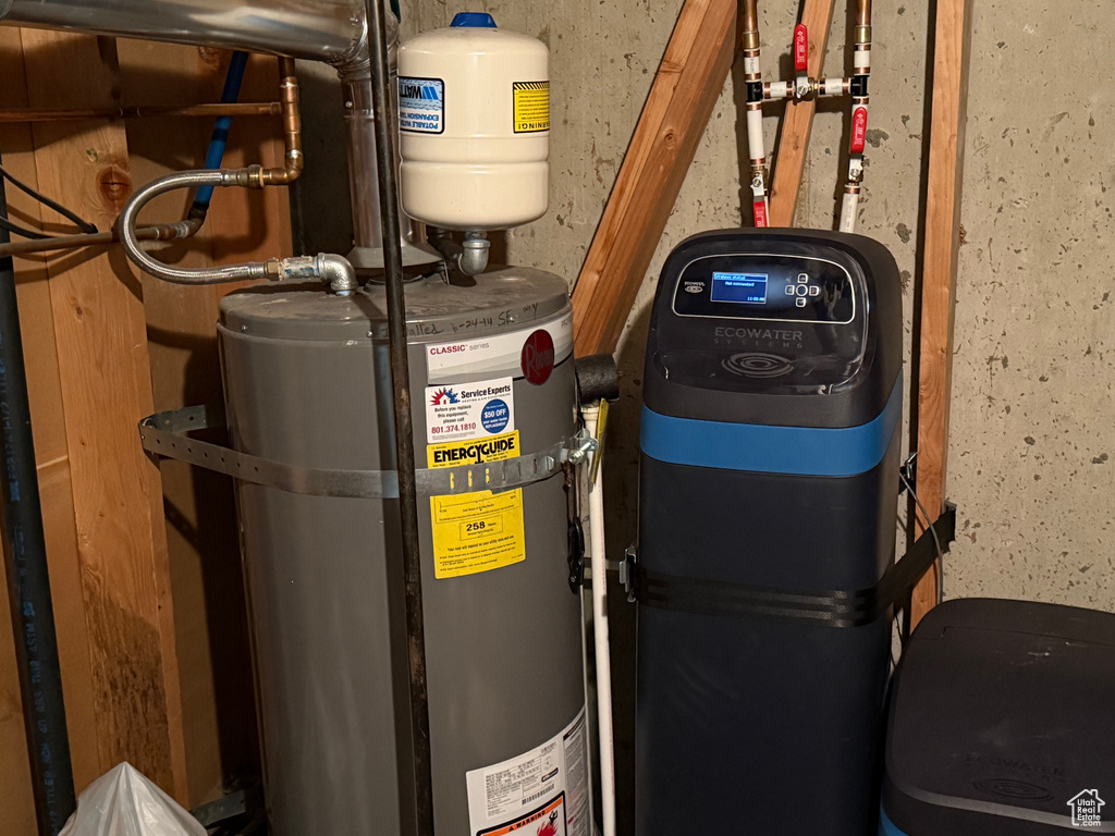 Utility room featuring secured water heater