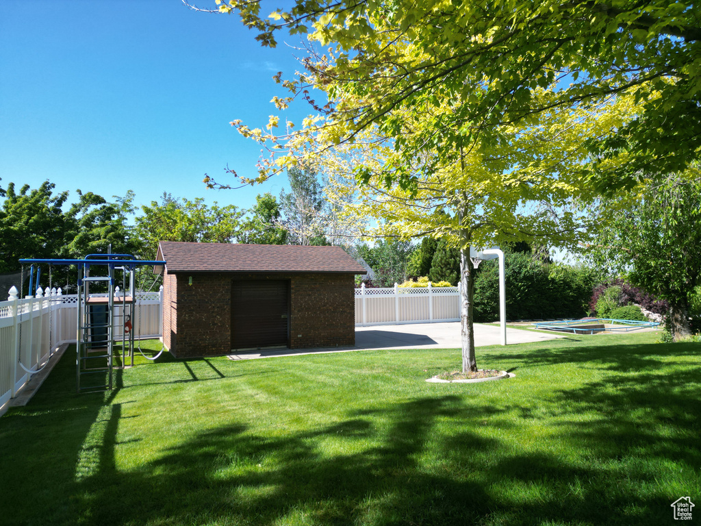 View of yard with an outbuilding and a playground