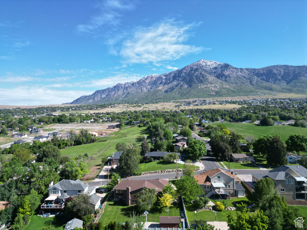 Aerial overview of property\'s location featuring mountains and nearby suburban area