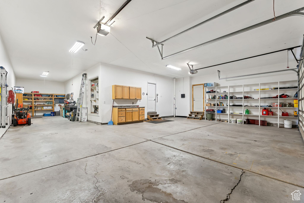 Garage with a garage door opener and a workshop area