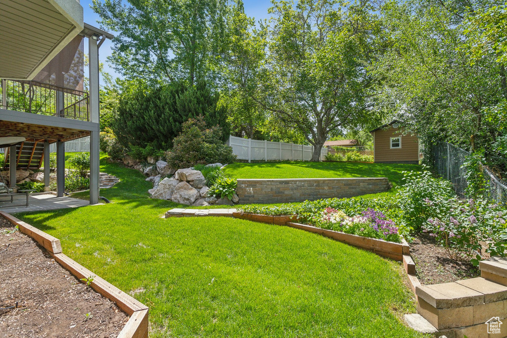 View of yard featuring a patio, a sunroom, and stairway