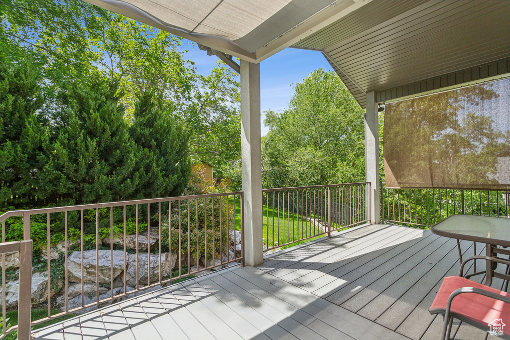 Wooden deck featuring view of wooded area