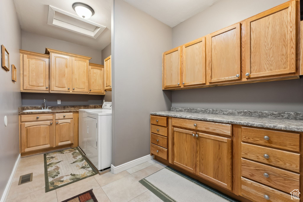 Laundry room with cabinet space, attic access, visible vents, washer / clothes dryer, and a sink