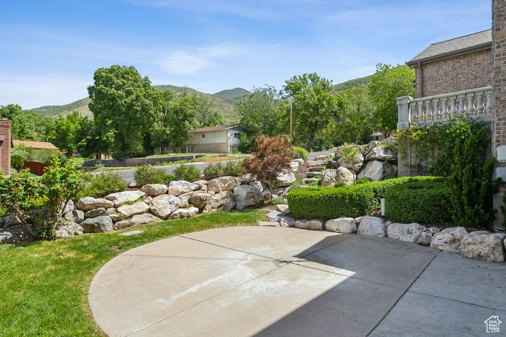 View of yard with a patio and a mountain view