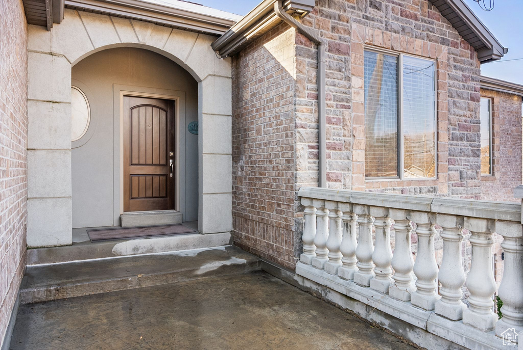 View of exterior entry featuring brick siding