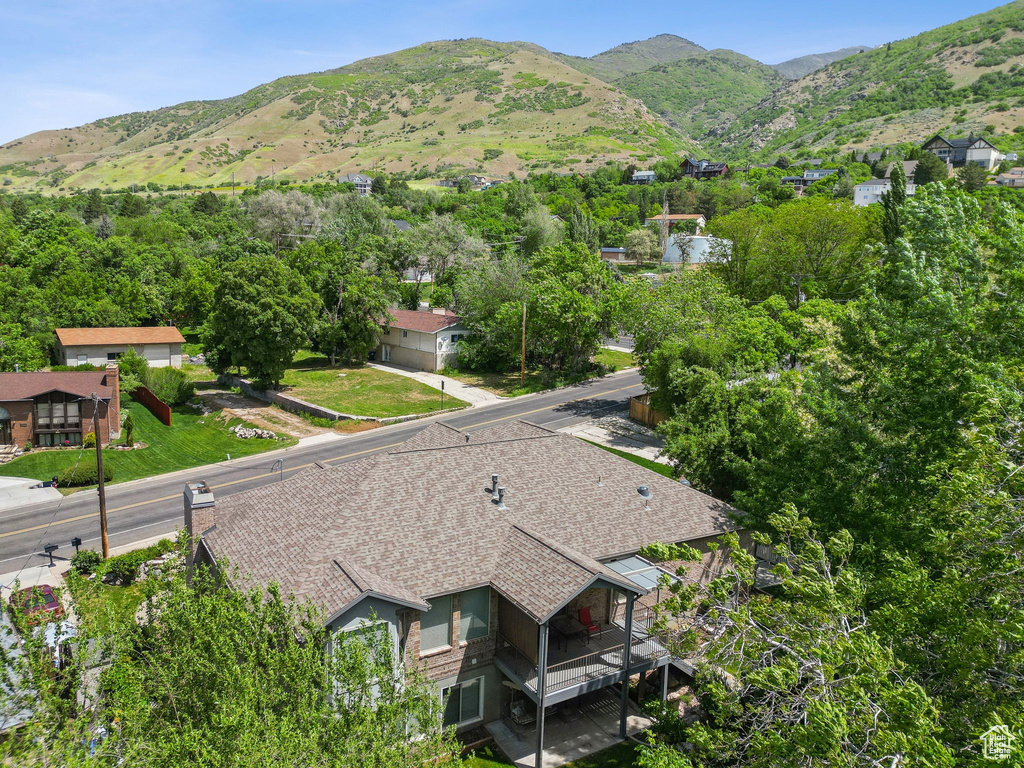 Aerial view of property and surrounding area featuring a mountain backdrop