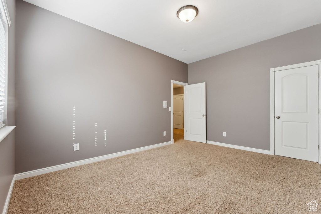 Empty room with baseboards and carpet flooring