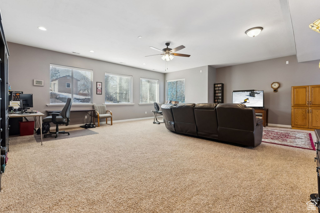Carpeted living area with baseboards, a ceiling fan, and recessed lighting