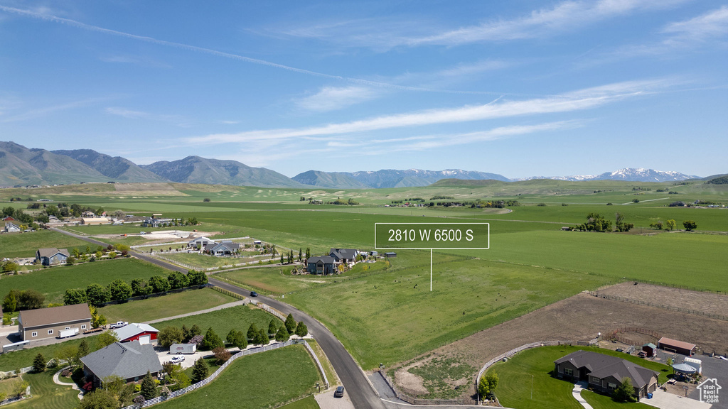 Aerial view of property and surrounding area with a mountainous background